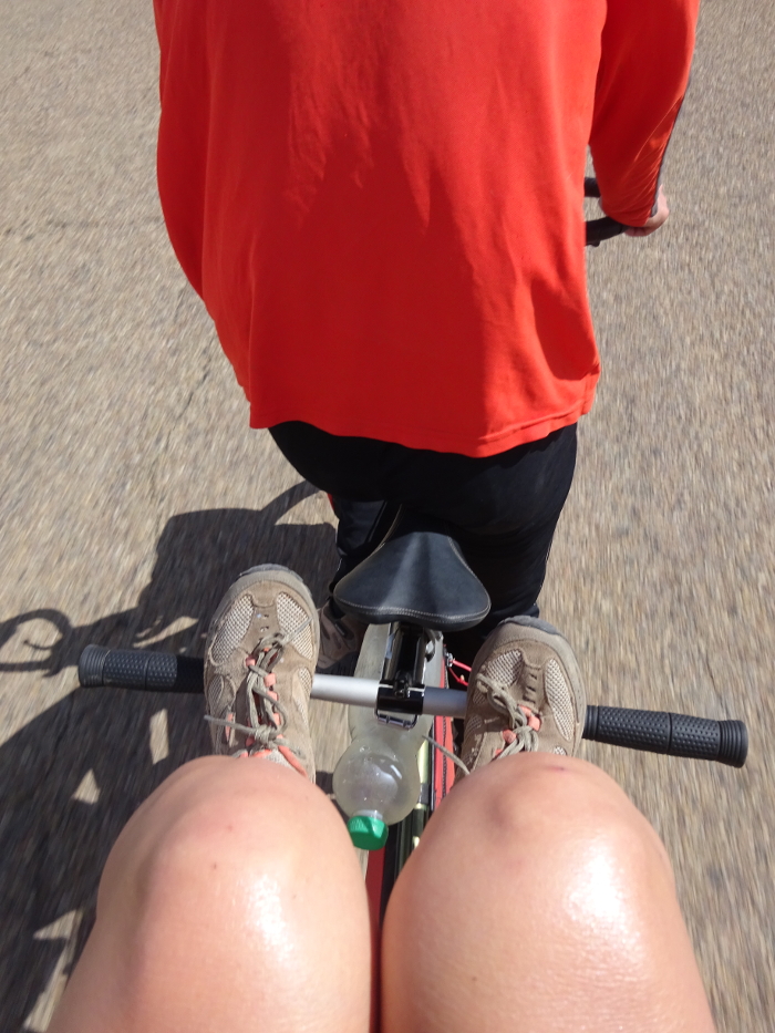 stoker with her feet up on a tandem bike